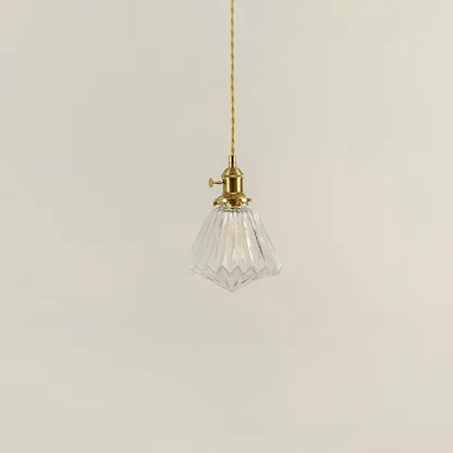 Clear textured glass and brass metal pendant light with vintage styling for refined interior spaces.
