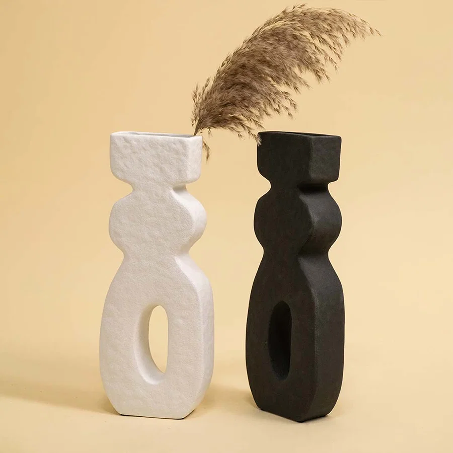 Set of black and white ceramic abstract sculptures with dried stems for artistic modern home decor displays.