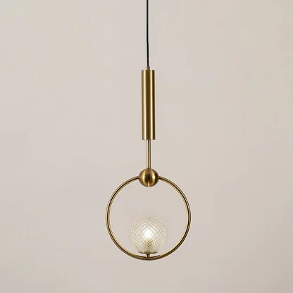 Gold metal pendant light with clear glass ring illuminated to display contemporary decorative ceiling lighting elegance.