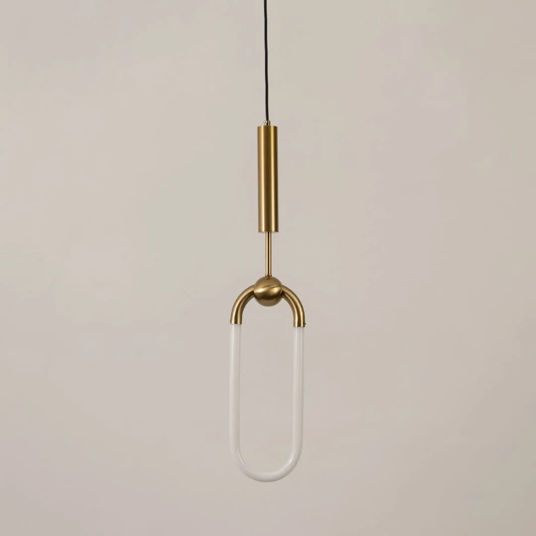 Gold metal pendant light with frosted acrylic loop illuminated to display sleek decorative lighting and modern appeal.
