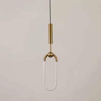 Gold metal pendant light with frosted acrylic loop illuminated to display sleek decorative lighting and modern appeal.