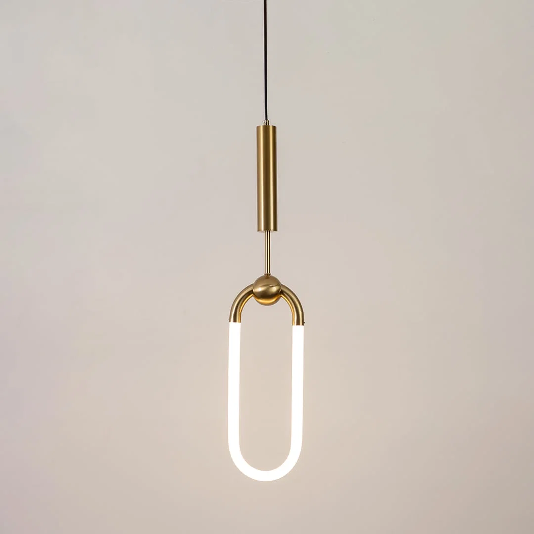 Gold metal pendant light with frosted acrylic loop illuminated to showcase minimalist contemporary ceiling lighting.