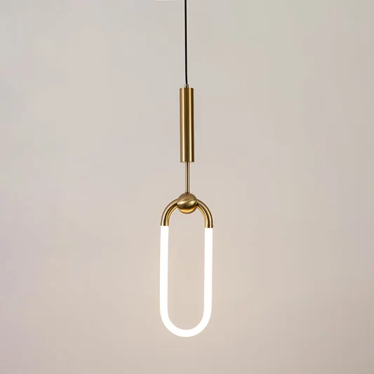 Gold metal pendant light with frosted acrylic loop illuminated to showcase minimalist contemporary ceiling lighting.