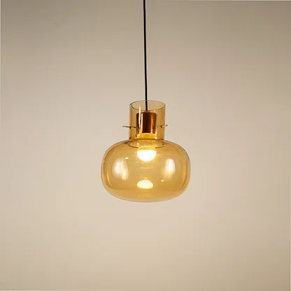 Amber glass pendant light displaying elegant hanging design with warm decorative appeal and contemporary styling.