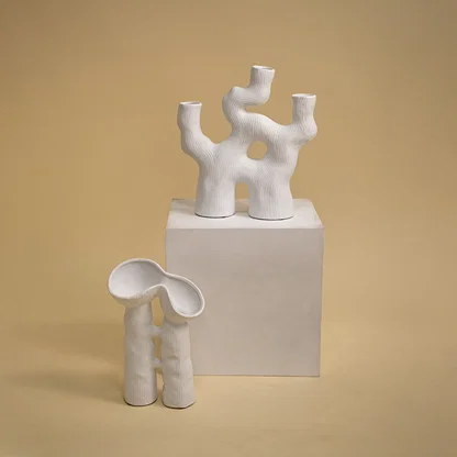 White ceramic abstract decorative sculpture with artistic form for contemporary shelf styling and modern home decor.