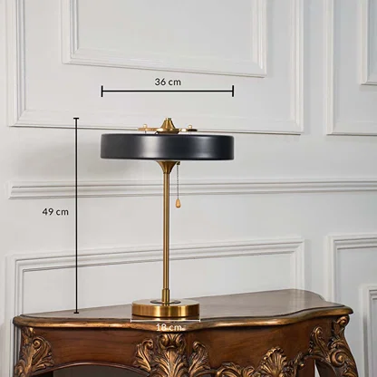 Black and gold modern table lamp with circular shade shown with 49 cm height and 36 cm width for accurate sizing.