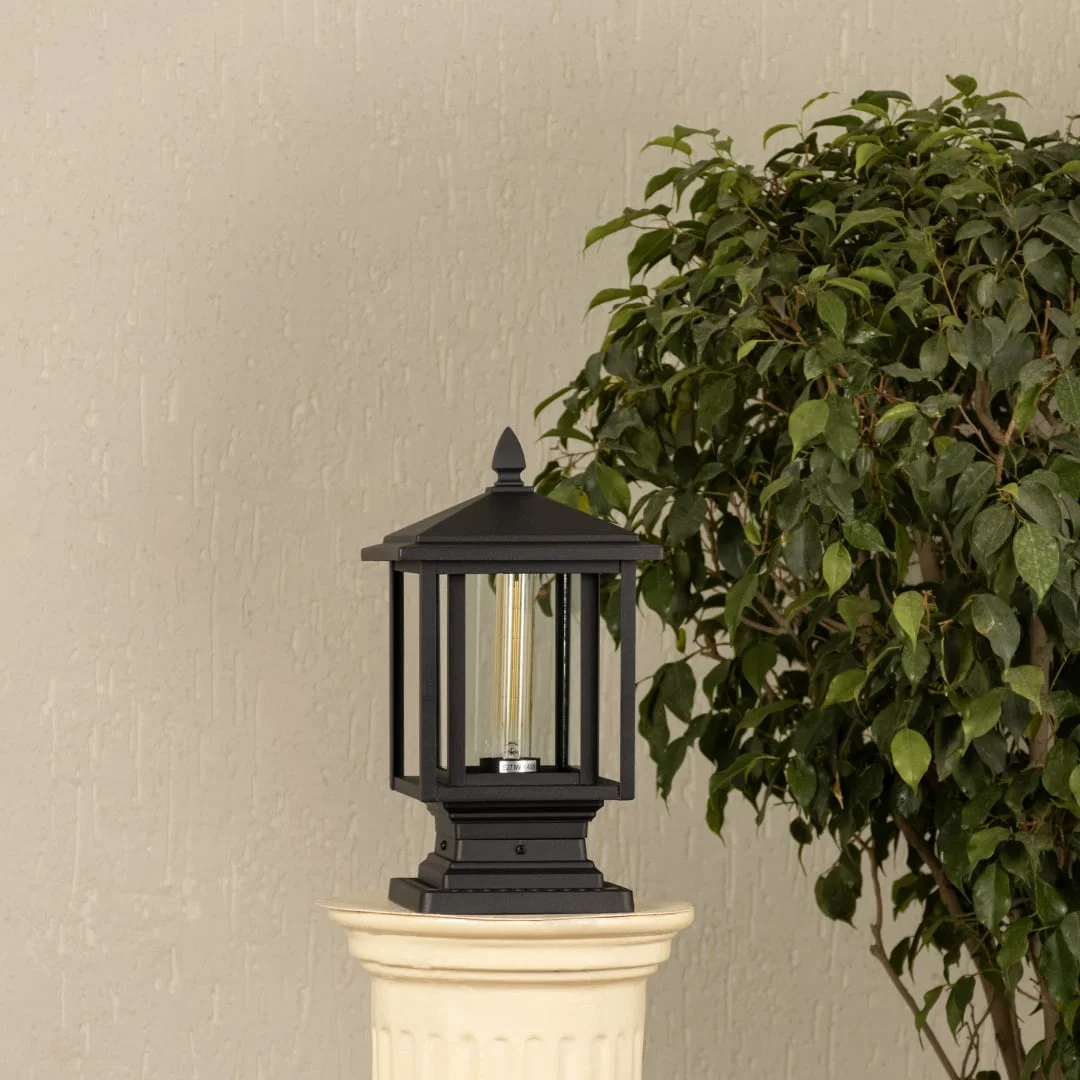 Black outdoor pillar lantern Light Off White Background image showing ribbed glass and a clean metal cap design.