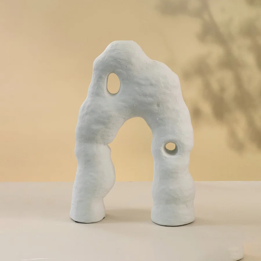White ceramic abstract decorative sculpture set with artistic organic silhouettes for contemporary home decor styling.