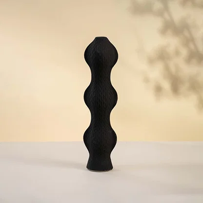 Black ceramic decorative vase with stacked sculptural silhouette for contemporary tabletop styling and home decor.