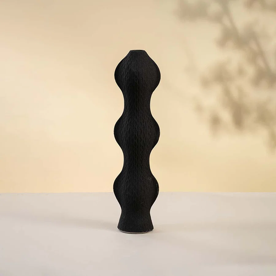 Black ceramic decorative vase with stacked sculptural silhouette for contemporary tabletop styling and home decor.
