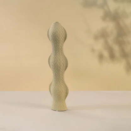 Beige ceramic decorative vase with stacked sculptural design for elegant shelf styling and contemporary home decor.