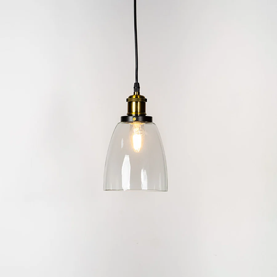 Clear glass pendant light with brass finish metal holder and minimalist design for elegant ceiling lighting decor.