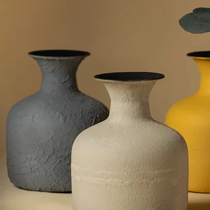 A detailed view of the beige vase highlights its textured surface and handcrafted matte finish showing the organic imperfections that give it a unique artisanal quality.