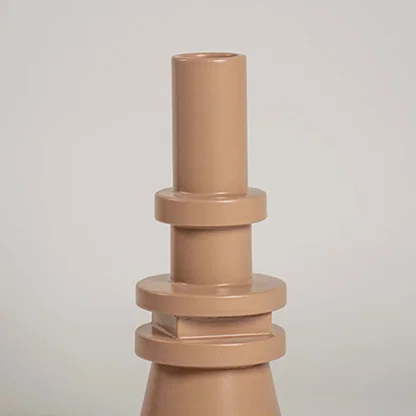 Closeup view of the beige sculptural vase highlighting its layered geometric details and sleek smooth texture that add a bold artistic touch to decor.