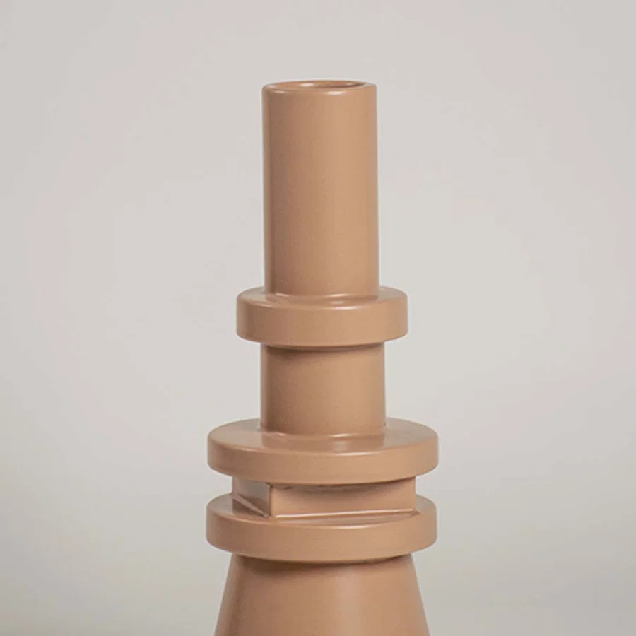 Closeup view of the beige sculptural vase highlighting its layered geometric details and sleek smooth texture that add a bold artistic touch to decor.