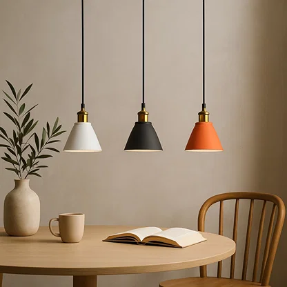 Black and terracotta metal pendant lights above dining table bringing modern warmth and stylish appeal.