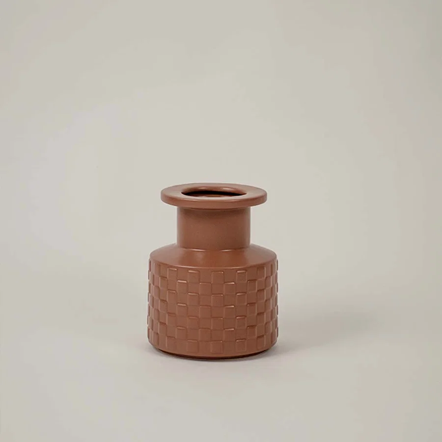 Terracotta ceramic decorative vase with textured pattern and compact form for elegant tabletop styling and home decor.
