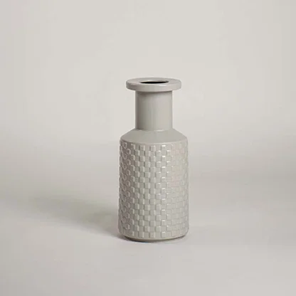 White textured ceramic bottle vase with narrow neck for console table styling and modern home decor display.