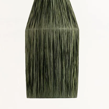 Green textured decor vase with vertical pattern ideal for modern table or shelf decor placement in home interior setting.