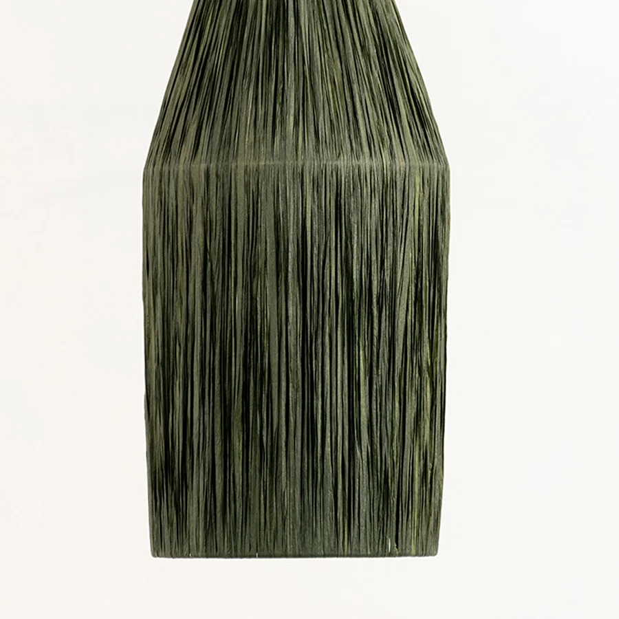 Green textured decor vase with vertical pattern ideal for modern table or shelf decor placement in home interior setting.