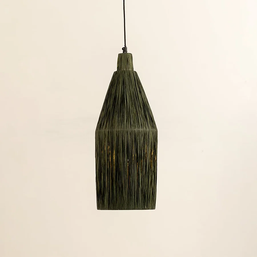 Green woven fiber pendant light illuminated to highlight textured craftsmanship and modern organic lighting design.