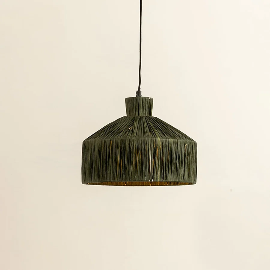 Green woven fiber pendant light illuminated to showcase organic decorative ceiling lighting with artisanal appeal.