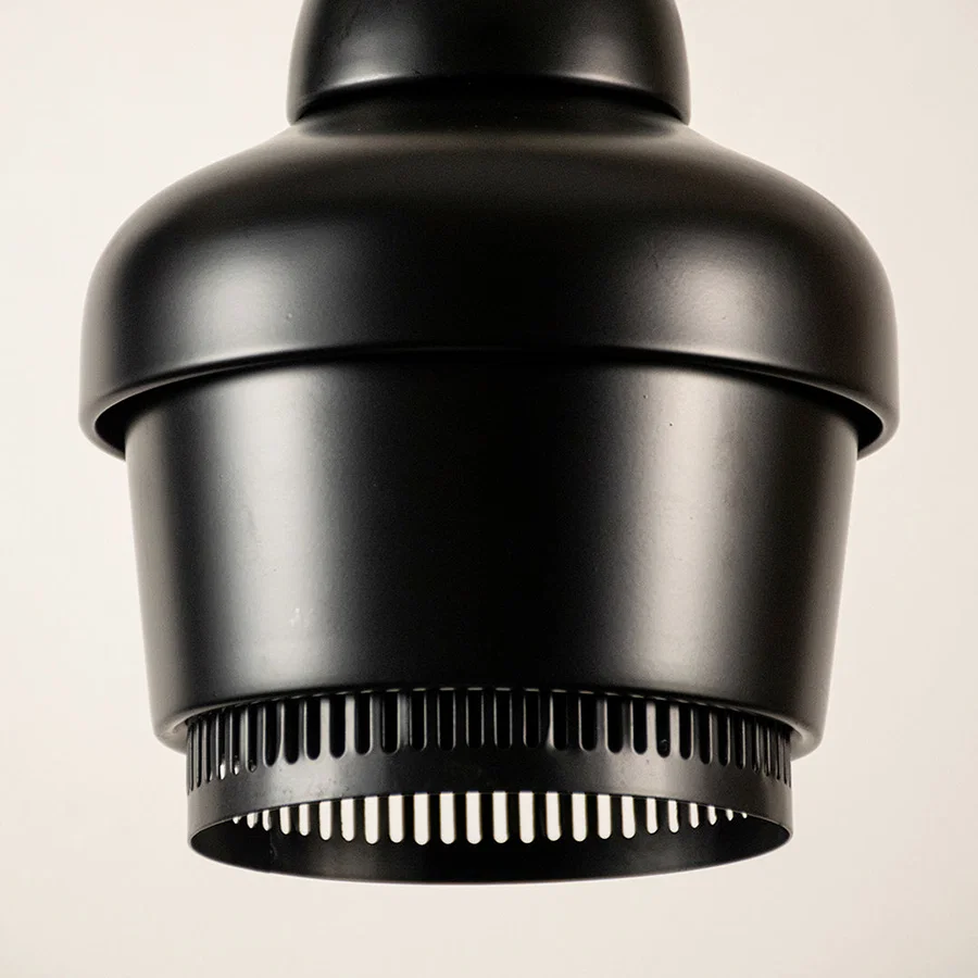 Black metal pendant light closeup highlighting industrial detailing and premium craftsmanship with modern decorative appeal.