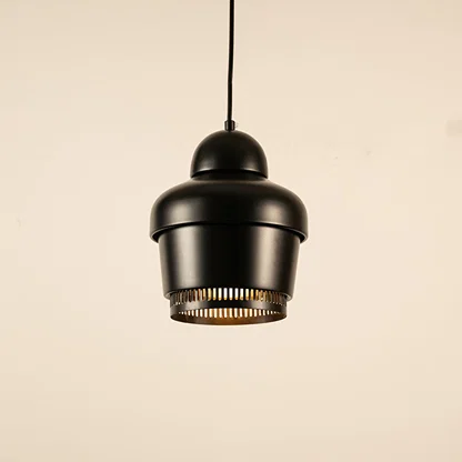 Black metal pendant light with industrial design illuminated to highlight modern ceiling lighting and warm glow.