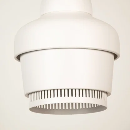 White metal pendant light closeup featuring refined detailing and premium modern lighting craftsmanship quality.