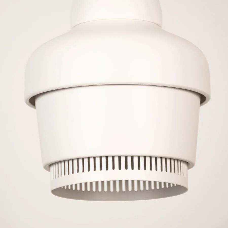 White metal pendant light closeup featuring refined detailing and premium modern lighting craftsmanship quality.