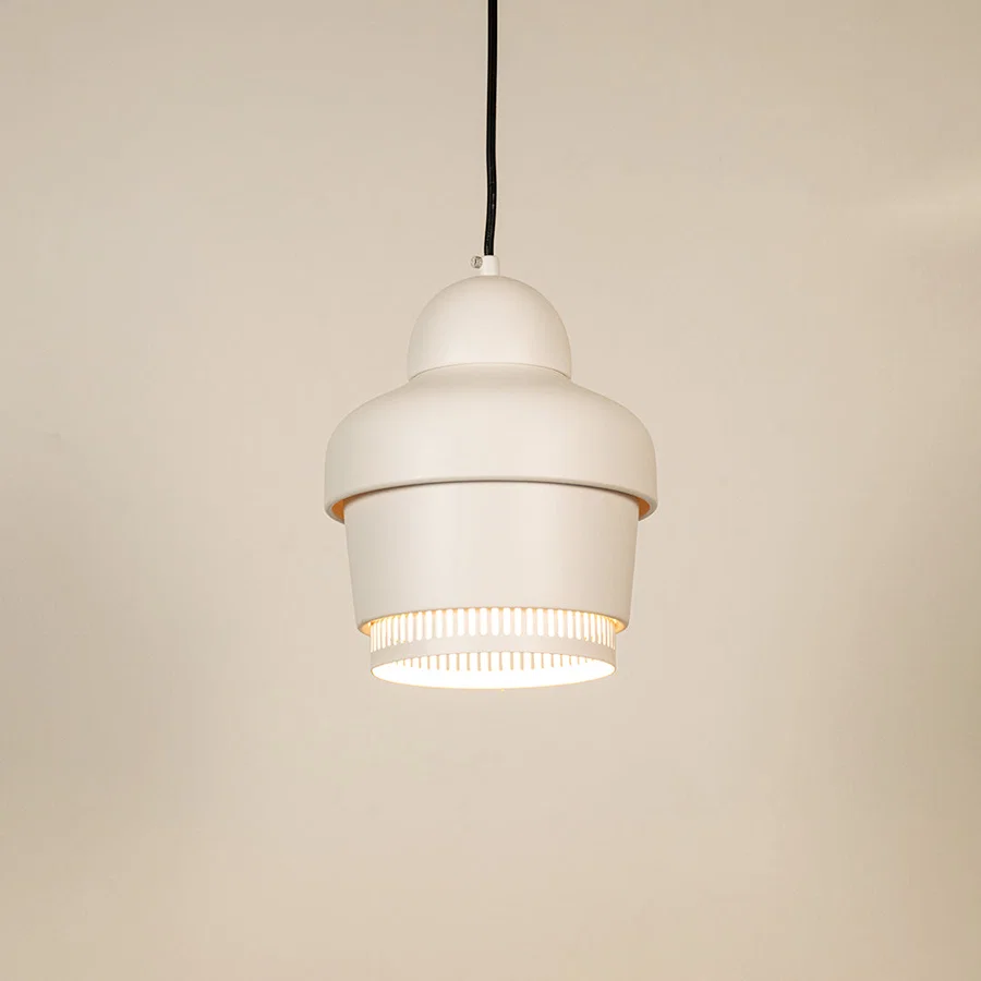 White metal pendant light illuminated to showcase contemporary ceiling lighting with clean minimalist design appeal.