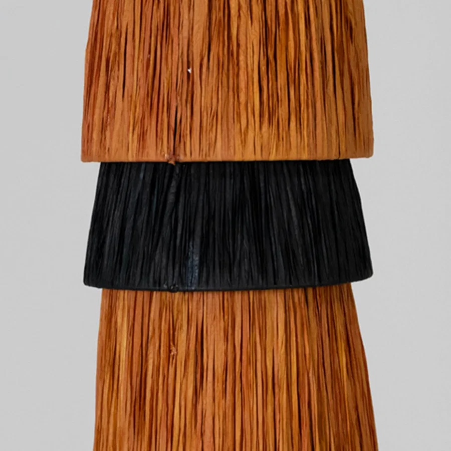 Natural brown and black fiber wall light closeup highlighting woven detailing and premium handmade construction.
