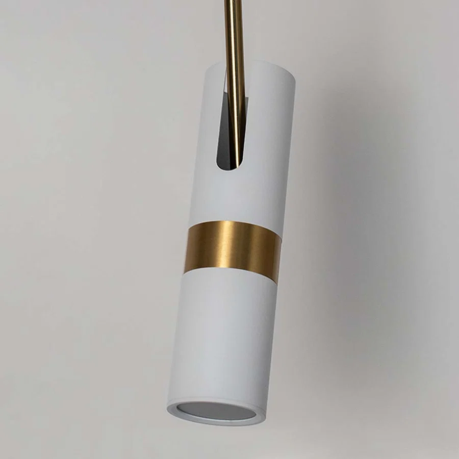 Closeup of white cylindrical pendant light with polished gold details showcasing premium craftsmanship.