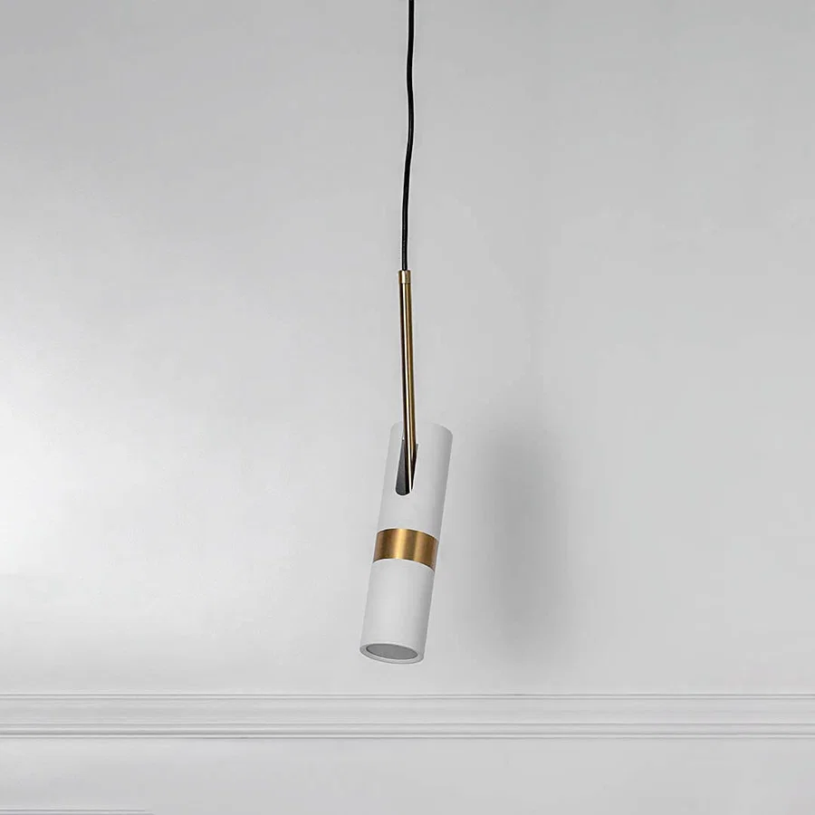 White pendant light with gold accent and hanging cord placed against neutral wall background showcasing minimal stylish lighting decor appeal.
