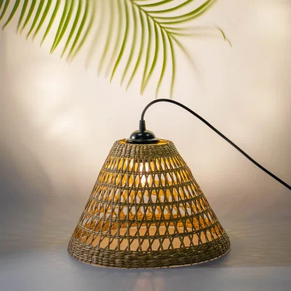 Handwoven rattan table lamp with black curved arm creating warm bohemian lighting and natural charm.