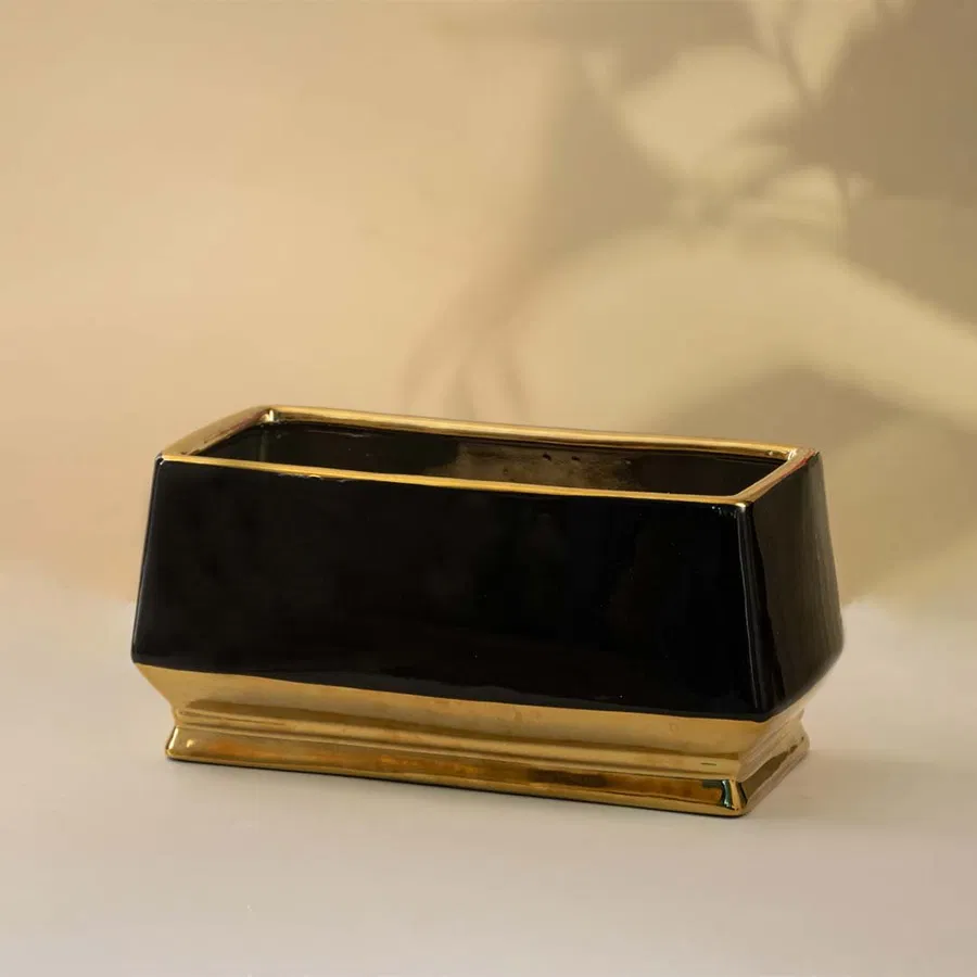 Black marble decorative tray with gold frame for contemporary tabletop styling and elegant home decor displays.