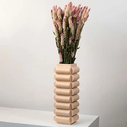 Dried flower styled in a tall ceramic vase creating a warm natural home décor accent with a soft earthy aesthetic perfect for modern interior styling.