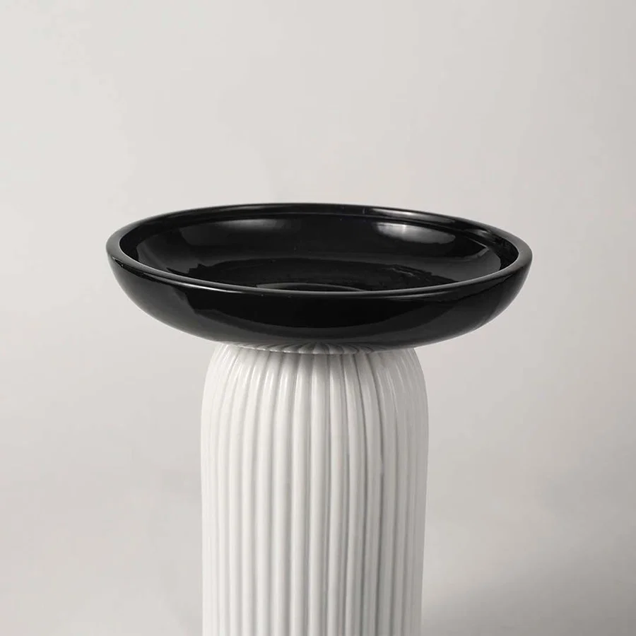 Black and white ceramic decorative vase with fluted base for tabletop styling and luxury modern home decor.