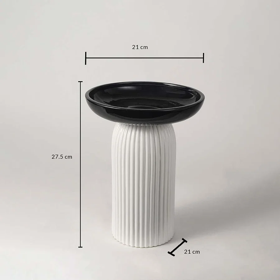 A black and white pedestal bowl shown with measurements of 27.5 cm height and 21 cm width providing clear size details for buyers.