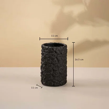 Black cylindrical ceramic vase featuring 22 cm height and 12 cm width displayed on a beige background.
