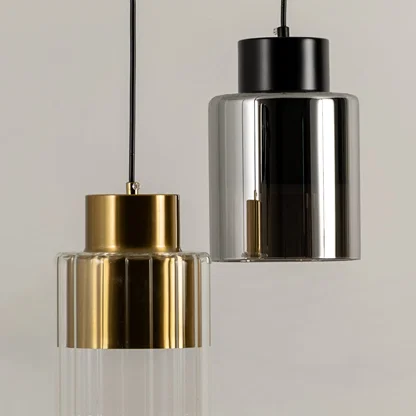 Gold and black metal pendant lights illuminated to showcase contemporary ceiling lighting with luxury modern appeal.