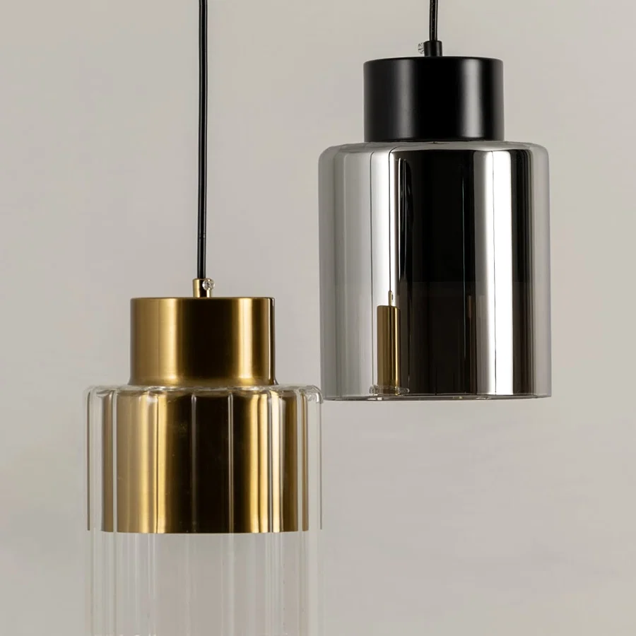 Gold and black metal pendant lights illuminated to showcase contemporary ceiling lighting with luxury modern appeal.