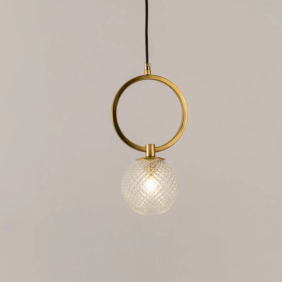 Gold metal pendant light with circular frame and textured glass globe on white background perfect for modern interior lighting decor.