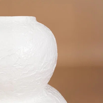 Closeup of white textured decorative vase showing handcrafted surface detail and sculptural form ideal for modern artistic home decor.