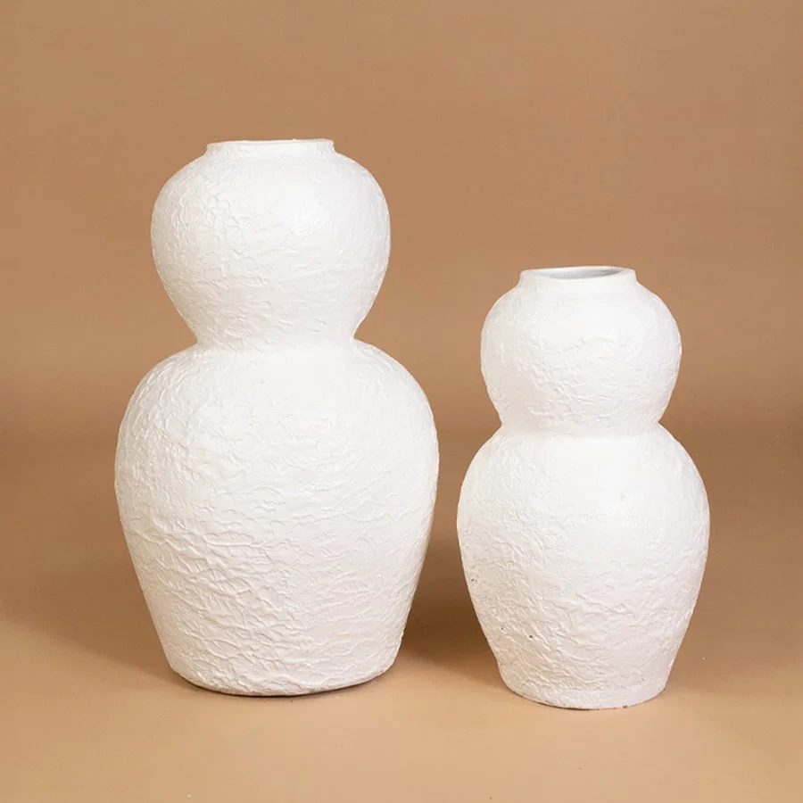 White textured decorative vase displayed with matching modern decor items creating a stylish grouped presentation for contemporary interiors.