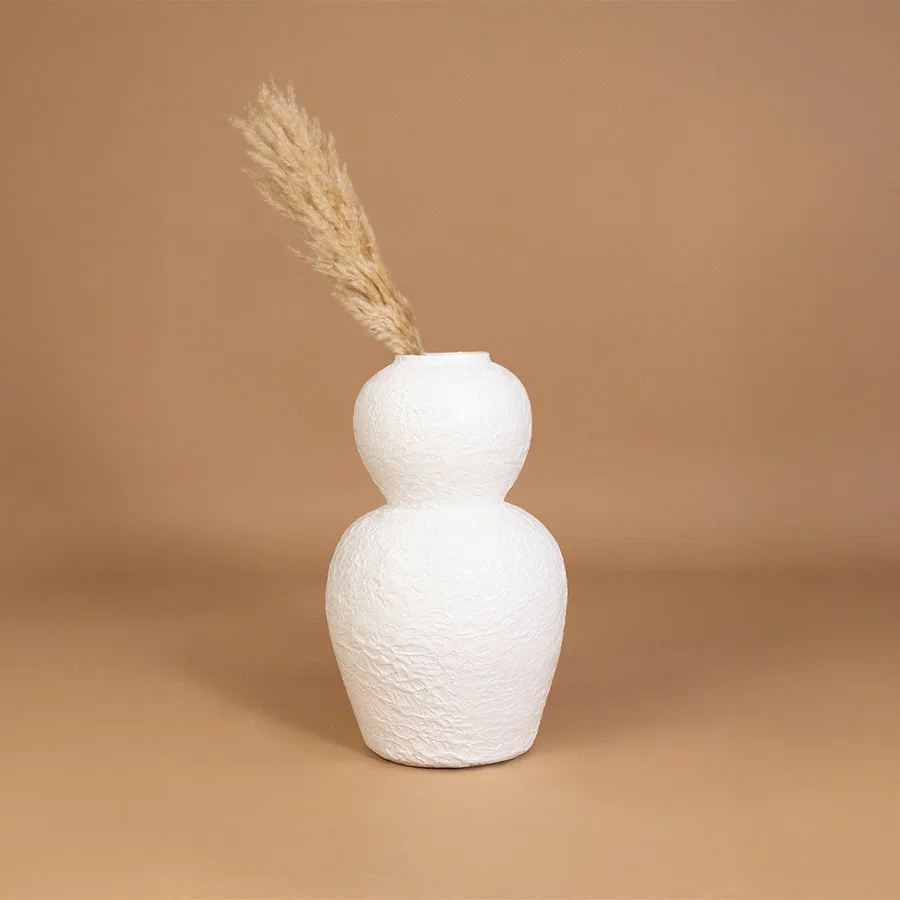 Minimal ceramic vase in white finish with dried grass for table decor or shelf styling modern home placement neutral background.