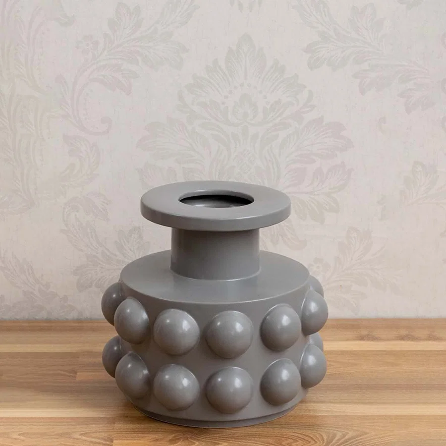 Grey ceramic decorative vase with sculptural bubble design styled on a table for contemporary home decor settings.