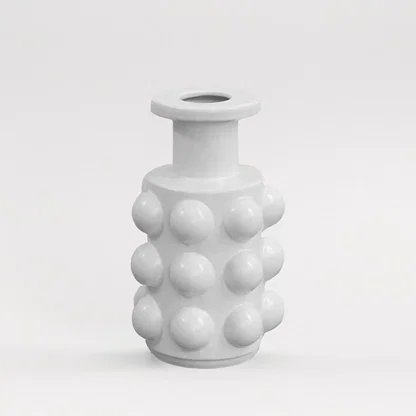 Matte white ceramic cylinder bottle vase featuring a bold raised hobnail studded texture on white background for art decor.