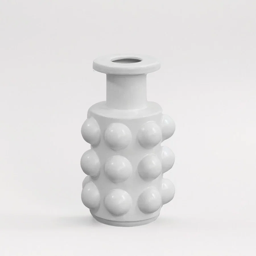Matte white ceramic cylinder bottle vase featuring a bold raised hobnail studded texture on white background for art decor.