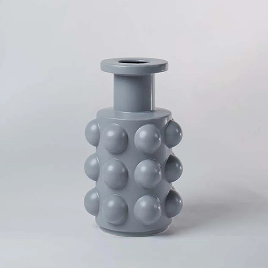 Grey ceramic decorative vase with bubble texture and rounded silhouette for contemporary shelf styling and decor.
